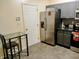 Efficient kitchen with gray cabinets, stainless steel refrigerator, and a cozy breakfast nook, providing a functional and welcoming space at 8333 Pine Branch Ln, Indianapolis, IN 46234