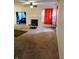 Living room featuring neutral carpet, fireplace and pass-through to the second Gathering room at 8333 Pine Branch Ln, Indianapolis, IN 46234
