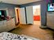 Spacious bedroom with ensuite bathroom, TV, soft carpet, and ample closet space at 8333 Pine Branch Ln, Indianapolis, IN 46234