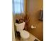 A powder room featuring a toilet and decoratively adorned toilet tank at 8333 Pine Branch Ln, Indianapolis, IN 46234