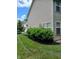 A side yard featuring vinyl siding and a landscaped area with trimmed bushes at 8333 Pine Branch Ln, Indianapolis, IN 46234