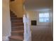 Carpeted staircase leading to the home's main level, with a living room in the background at 8333 Pine Branch Ln, Indianapolis, IN 46234