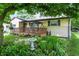 Beautiful backyard featuring a quaint deck with swing and lush landscaping at 9042 Panorama Ct, Indianapolis, IN 46234