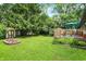 Expansive backyard featuring a lush lawn, a charming garden bed, a storage shed, and a wooden deck for relaxation at 9042 Panorama Ct, Indianapolis, IN 46234