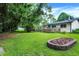 Lush backyard showcases a blooming garden bed and spacious deck, ideal for outdoor gatherings and relaxation at 9042 Panorama Ct, Indianapolis, IN 46234