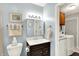 This bathroom features a toilet, sink, mirror, and laundry machines in the next room at 9042 Panorama Ct, Indianapolis, IN 46234