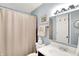 This bathroom features a toilet, sink, mirror, and shower at 9042 Panorama Ct, Indianapolis, IN 46234