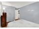 This bedroom features gray walls, hardwood floors, a full-sized bed, and closet with gray doors at 9042 Panorama Ct, Indianapolis, IN 46234