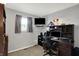 This bedroom features gray walls, carpet flooring, one window, and a desk with multiple electronic devices at 9042 Panorama Ct, Indianapolis, IN 46234