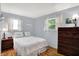 Cozy bedroom with two windows, hardwood floors, and neutral paint at 9042 Panorama Ct, Indianapolis, IN 46234