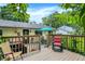 Spacious deck area with dining set and lounge chairs, ideal for outdoor entertaining and enjoying the serene backyard view at 9042 Panorama Ct, Indianapolis, IN 46234