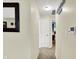 This hallway features carpet flooring, white walls, a decorative mirror, and 2 doorways leading to bedrooms at 9042 Panorama Ct, Indianapolis, IN 46234