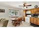 View of the dining area and kitchen featuring light wood cabinets and modern appliances at 9042 Panorama Ct, Indianapolis, IN 46234