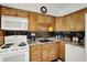 Close up of kitchen featuring light wood cabinets, white appliances, and dark backsplash at 9042 Panorama Ct, Indianapolis, IN 46234