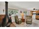 Open living room with fireplace, view into kitchen, and bright natural light at 9042 Panorama Ct, Indianapolis, IN 46234
