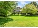 Spacious, well-maintained backyard with lush green lawn and mature trees offering a serene outdoor space at 10005 Southwind Dr, Indianapolis, IN 46256