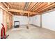 Unfinished basement space with exposed ceiling, concrete floor, and white painted walls and carpet, ready for customization at 10005 Southwind Dr, Indianapolis, IN 46256