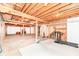 Unfinished basement with exposed ceiling, concrete floor, and white painted walls, ready for various uses at 10005 Southwind Dr, Indianapolis, IN 46256