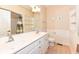 This bathroom features double sinks, a toilet, and a shower/tub with curtain and lots of storage at 10005 Southwind Dr, Indianapolis, IN 46256