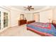 This bedroom boasts a ceiling fan, lovely furnishings, and private access to the backyard at 10005 Southwind Dr, Indianapolis, IN 46256