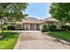 Charming brick home with a well-manicured lawn and a spacious driveway for curb appeal at 10005 Southwind Dr, Indianapolis, IN 46256