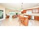 Spacious kitchen boasts wood cabinets, stainless steel appliances, an island with seating, and a comfortable seating area at 10005 Southwind Dr, Indianapolis, IN 46256