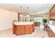 Open kitchen features an island with bar seating and a view into an adjoining living area with a garden view at 10005 Southwind Dr, Indianapolis, IN 46256