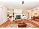 Inviting living room featuring a brick fireplace, hardwood floors, and open layout at 10005 Southwind Dr, Indianapolis, IN 46256