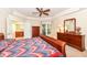 Carpeted main bedroom boasts a tray ceiling, ceiling fan, access to the ensuite bath and ample closet space at 10005 Southwind Dr, Indianapolis, IN 46256
