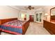 Relaxing main bedroom featuring carpet, a ceiling fan, adjoining bath access and ample closet space at 10005 Southwind Dr, Indianapolis, IN 46256