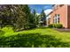 Spacious backyard with mature trees and a patio seating area near the house at 10480 Stonegate Dr, Fishers, IN 46040