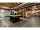 Unfinished basement with a pool table and exposed beams at 10480 Stonegate Dr, Fishers, IN 46040