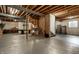 Unfinished basement area with exposed wood beams and concrete flooring at 10480 Stonegate Dr, Fishers, IN 46040