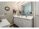 A bathroom with a double sink vanity with white cabinets and nautical themed decorations at 10480 Stonegate Dr, Fishers, IN 46040