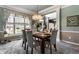 Dining room with modern chandelier, large windows, and seating for six at 10480 Stonegate Dr, Fishers, IN 46040