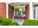 Charming front porch with hanging plants, a cozy bench, and decorative greenery at 10480 Stonegate Dr, Fishers, IN 46040
