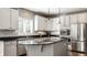 Close up of updated kitchen featuring stainless steel appliances, white cabinets, and granite countertops at 10480 Stonegate Dr, Fishers, IN 46040