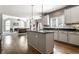 Open floor plan highlighting a bright kitchen with granite countertops and stainless steel appliances at 10480 Stonegate Dr, Fishers, IN 46040