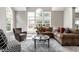 Spacious living room featuring large windows, comfortable seating, and stylish decor at 10480 Stonegate Dr, Fishers, IN 46040