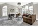 Bright living room with large windows, a fireplace, and stylish modern furniture at 10480 Stonegate Dr, Fishers, IN 46040