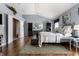 Comfortable main bedroom suite with chandelier lighting and hard wood floor at 10480 Stonegate Dr, Fishers, IN 46040