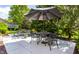 Outdoor patio with decorative furniture, potted plants, and lush landscaping at 10480 Stonegate Dr, Fishers, IN 46040
