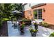 Outdoor patio with decorative furniture, potted plants, and lush landscaping at 10480 Stonegate Dr, Fishers, IN 46040