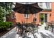 Outdoor patio featuring a table with an umbrella and a beautiful brick facade at 10480 Stonegate Dr, Fishers, IN 46040