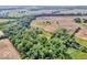 Lush green treetops hide a home, a harmonious blend of nature and real estate from a high-angle perspective at 10705 N State Road 267, Brownsburg, IN 46112