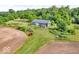 Aerial view featuring a barn, tractor, and various farming equipment in a rural setting at 10705 N State Road 267, Brownsburg, IN 46112