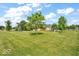 Beautifully manicured backyard with mature trees under a partially cloudy sky at 10705 N State Road 267, Brownsburg, IN 46112