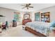 Comfortable bedroom with neutral tones, windows for natural light, and a ceiling fan at 10705 N State Road 267, Brownsburg, IN 46112