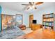 Cozy bedroom with ceiling fan, natural light, and a bookcase full of books at 10705 N State Road 267, Brownsburg, IN 46112