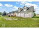 Spacious home with attached garages, a well-manicured lawn, and mature trees at 10705 N State Road 267, Brownsburg, IN 46112